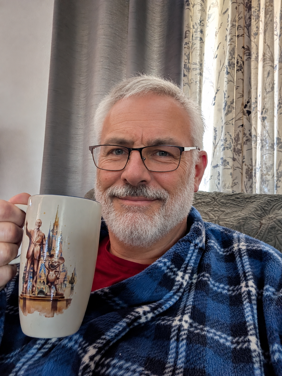 The host holding a mug at home